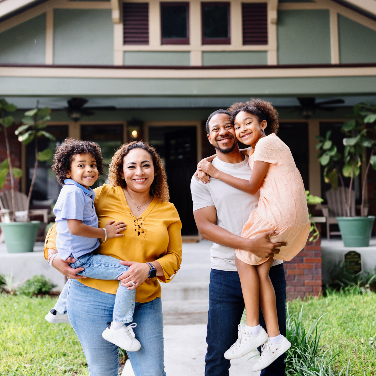 Family in front of house