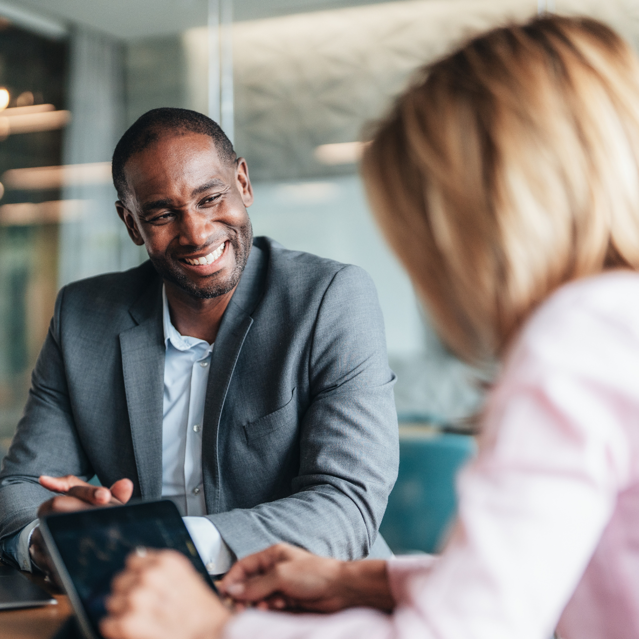 Man in a suit smiling at a woman