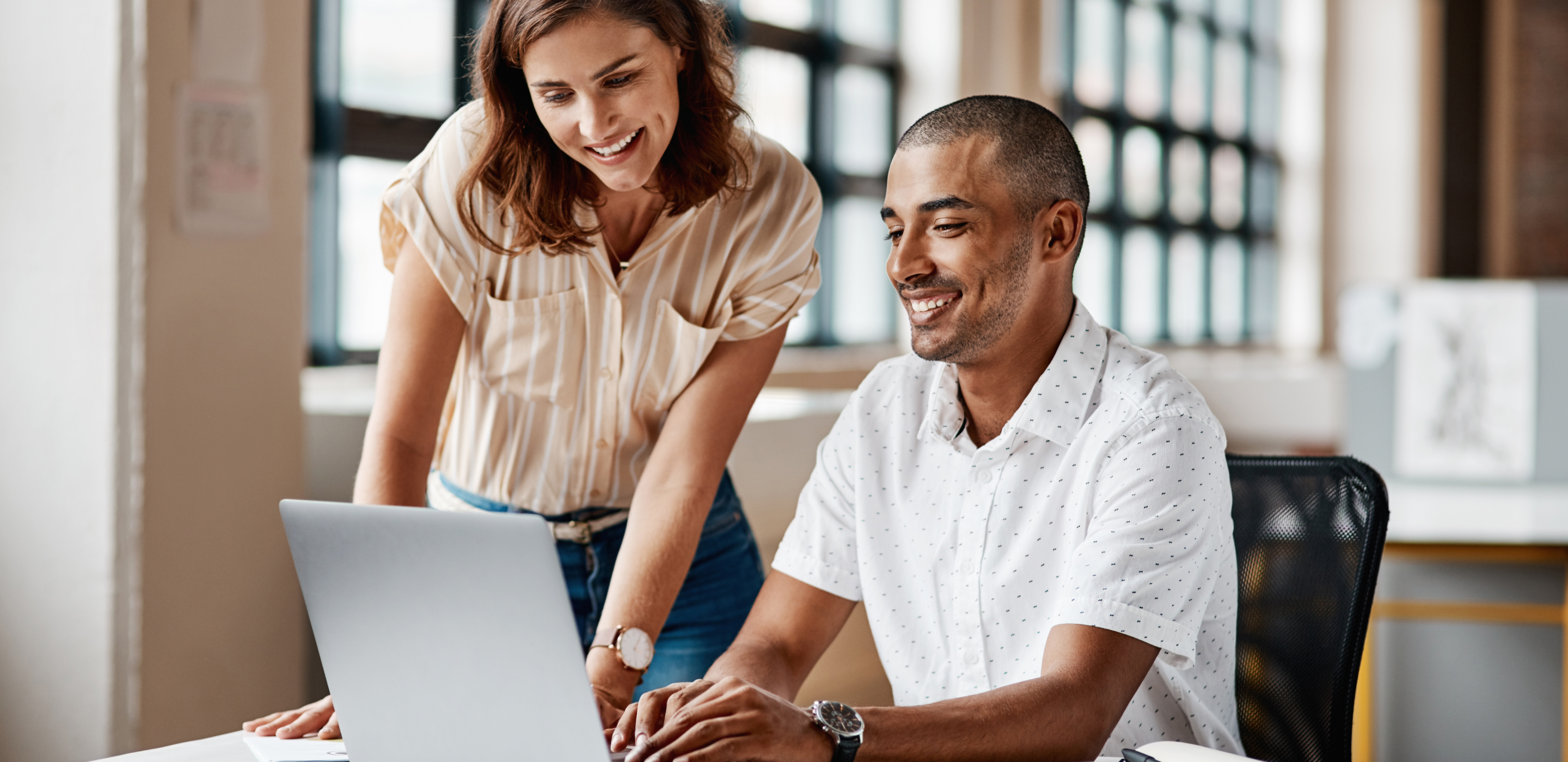 Man and a woman looking at a laptop